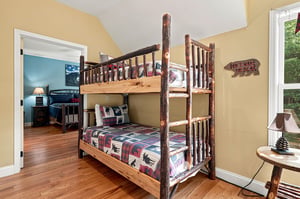 Settle in for the night in this cozy bunk room with rustic charm and wildernessthemed bedding thatll make bedtime an adventure.