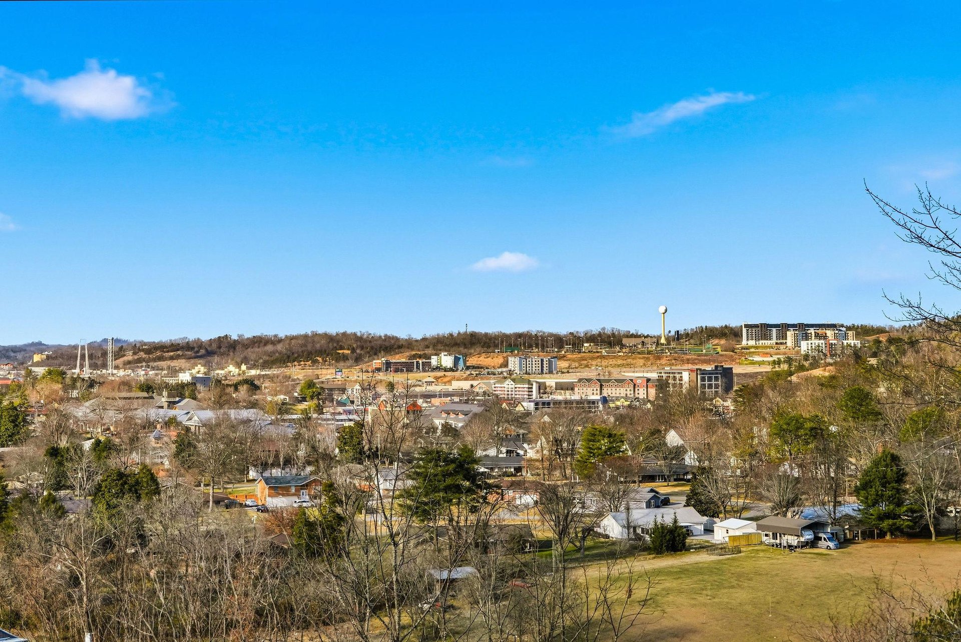 Panoramic view of the surrounding neighborhood and cityscape with rolling hills and clear blue skies.