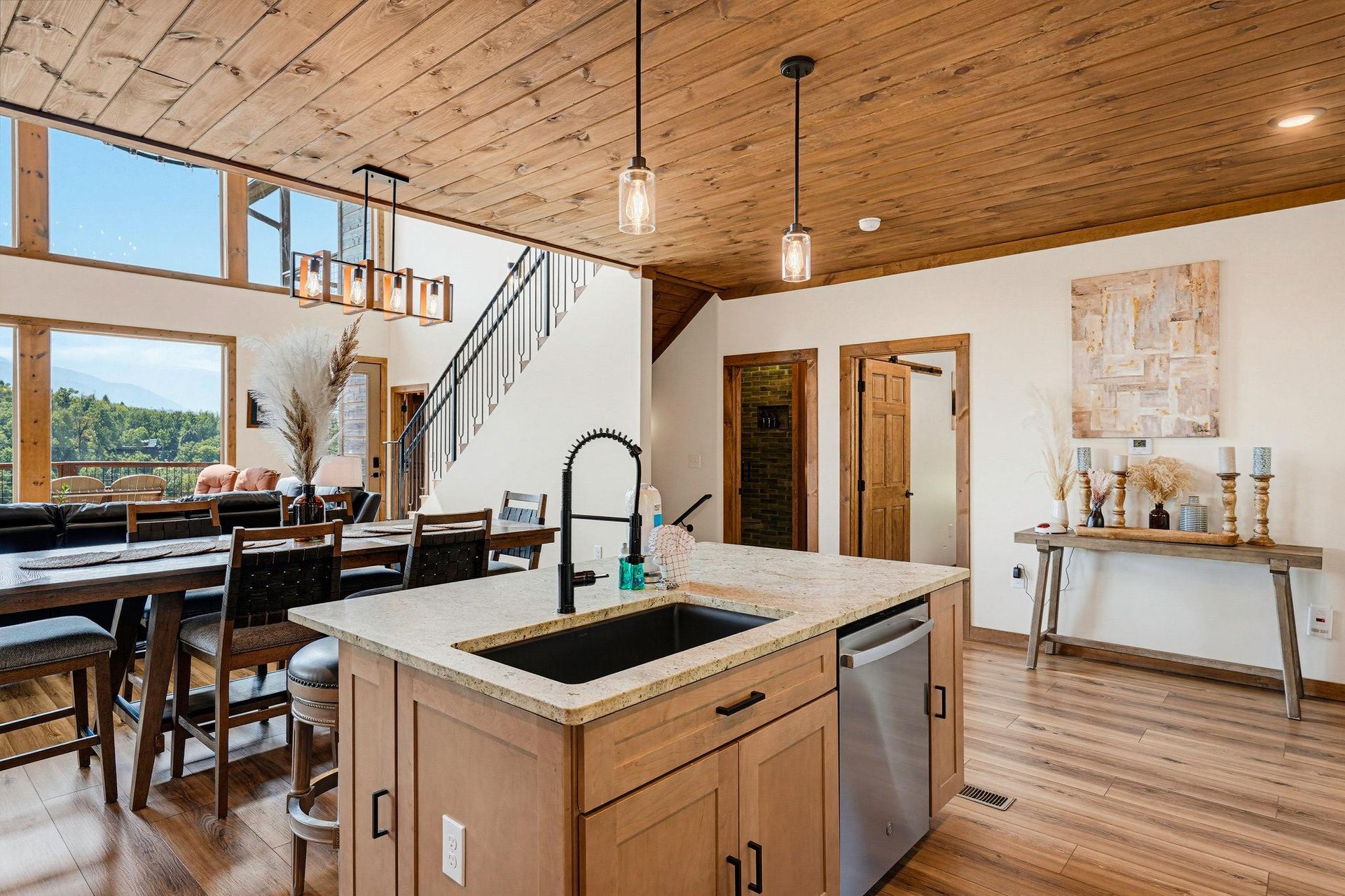 Relax under soaring wood ceilings while preparing meals at your island sink and enjoying sweeping mountain views through floortoceiling windows—your peaceful retreat blends rustic charm with modern 