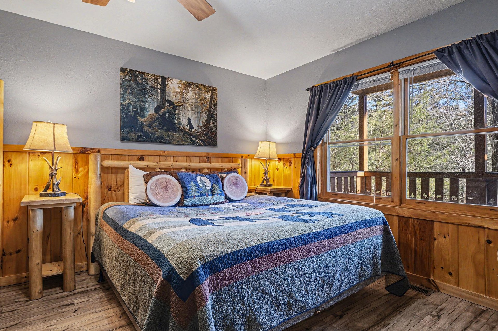 Drift off to peaceful sleep in your cozy bedroom, surrounded by warm wood accents and forest views from your private balcony.