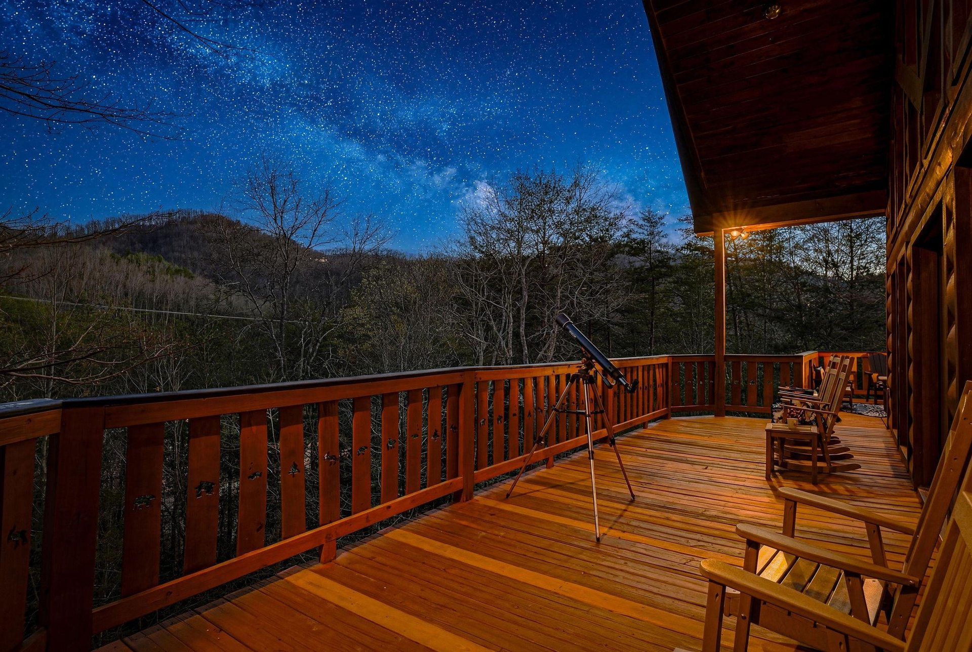 Stunning mountain property deck offers stargazing opportunities under brilliant night skies with telescope and comfortable seating.
