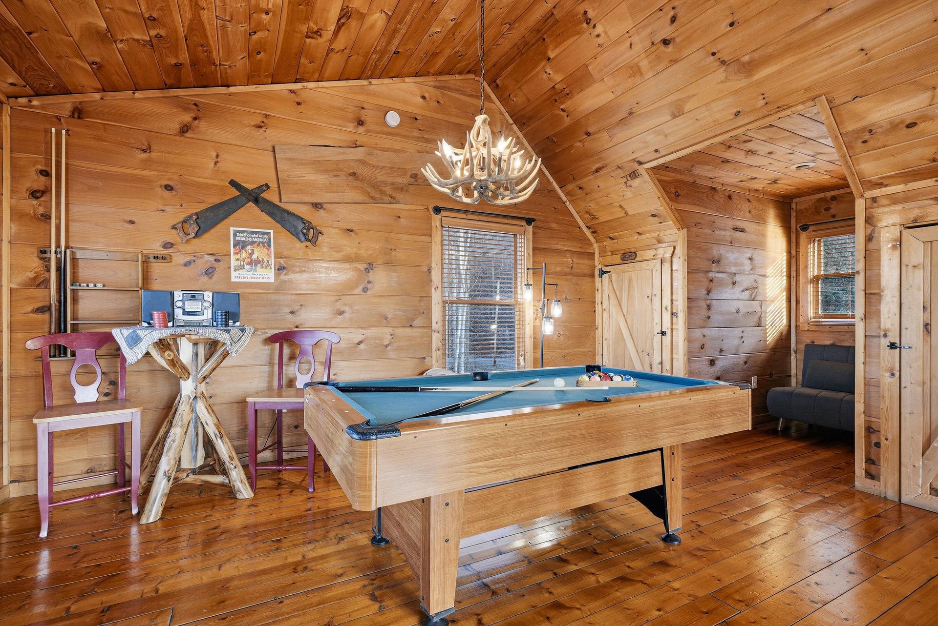 Challenge friends to pool while enjoying your rustic game rooms warm wood atmosphere and charming antler chandelier.