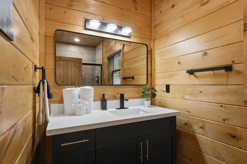 Step into your rusticmodern bathroom where warm wood walls meet sleek fixtures, creating the perfect blend of comfort and style.