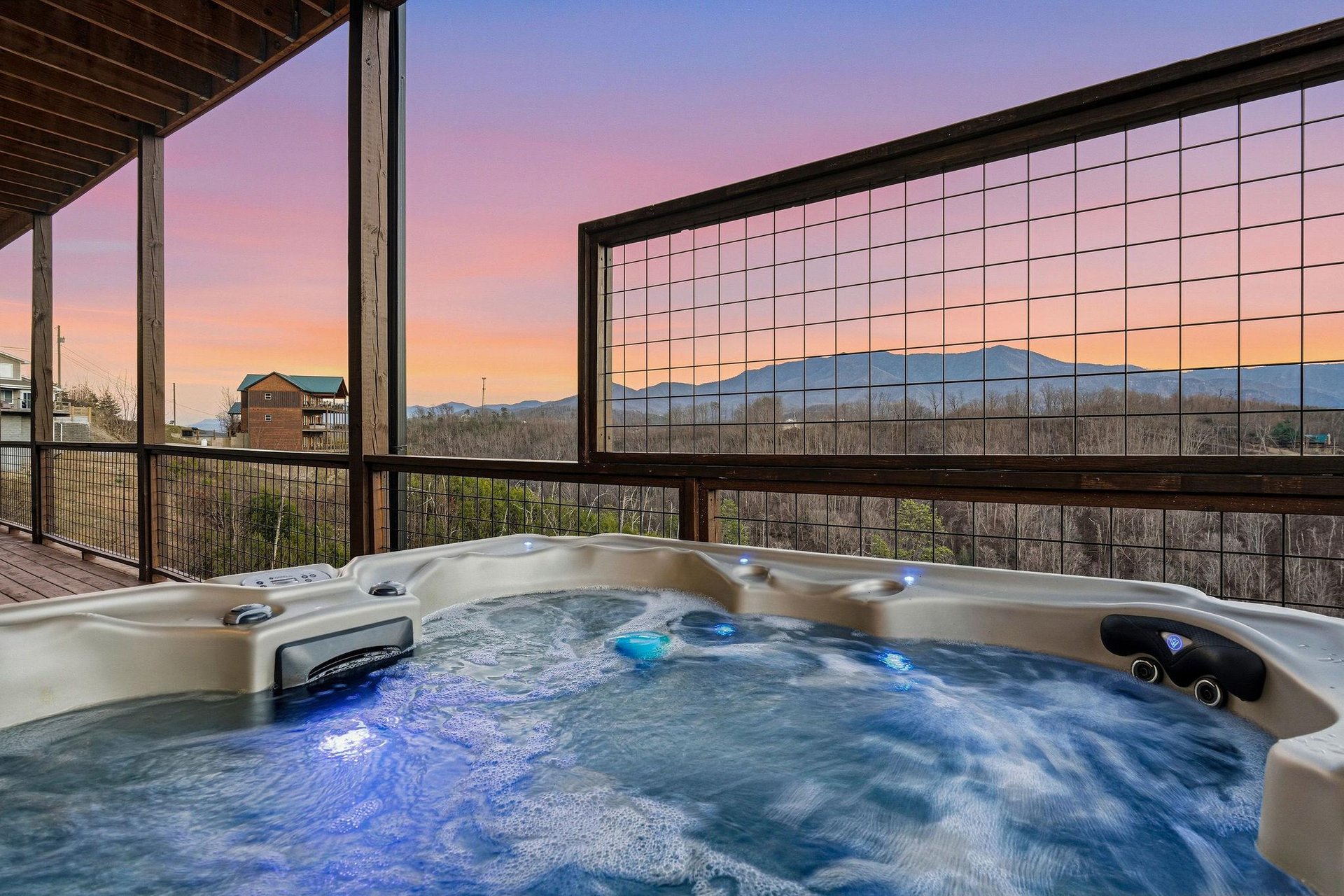 Unwind in your private hot tub as twilight paints the sky in soft pastels, with mountain views stretching endlessly before you.