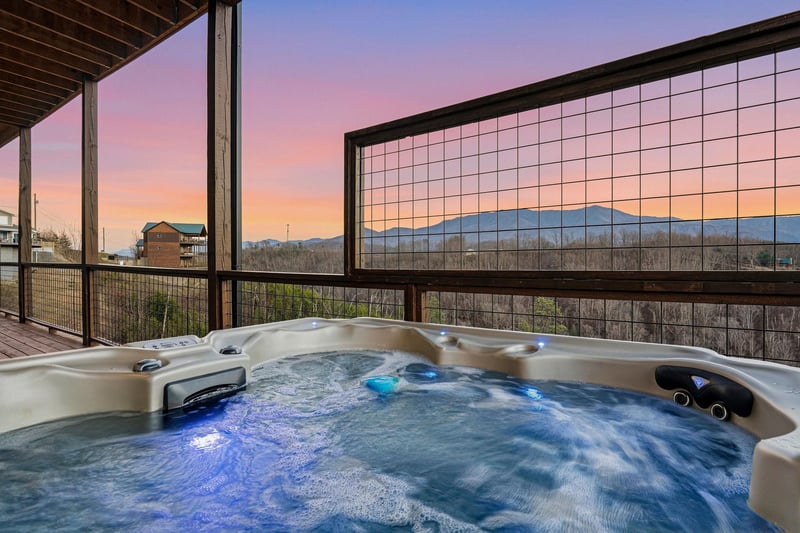 Unwind in your private hot tub as twilight paints the sky in soft pastels, with mountain views stretching endlessly before you.