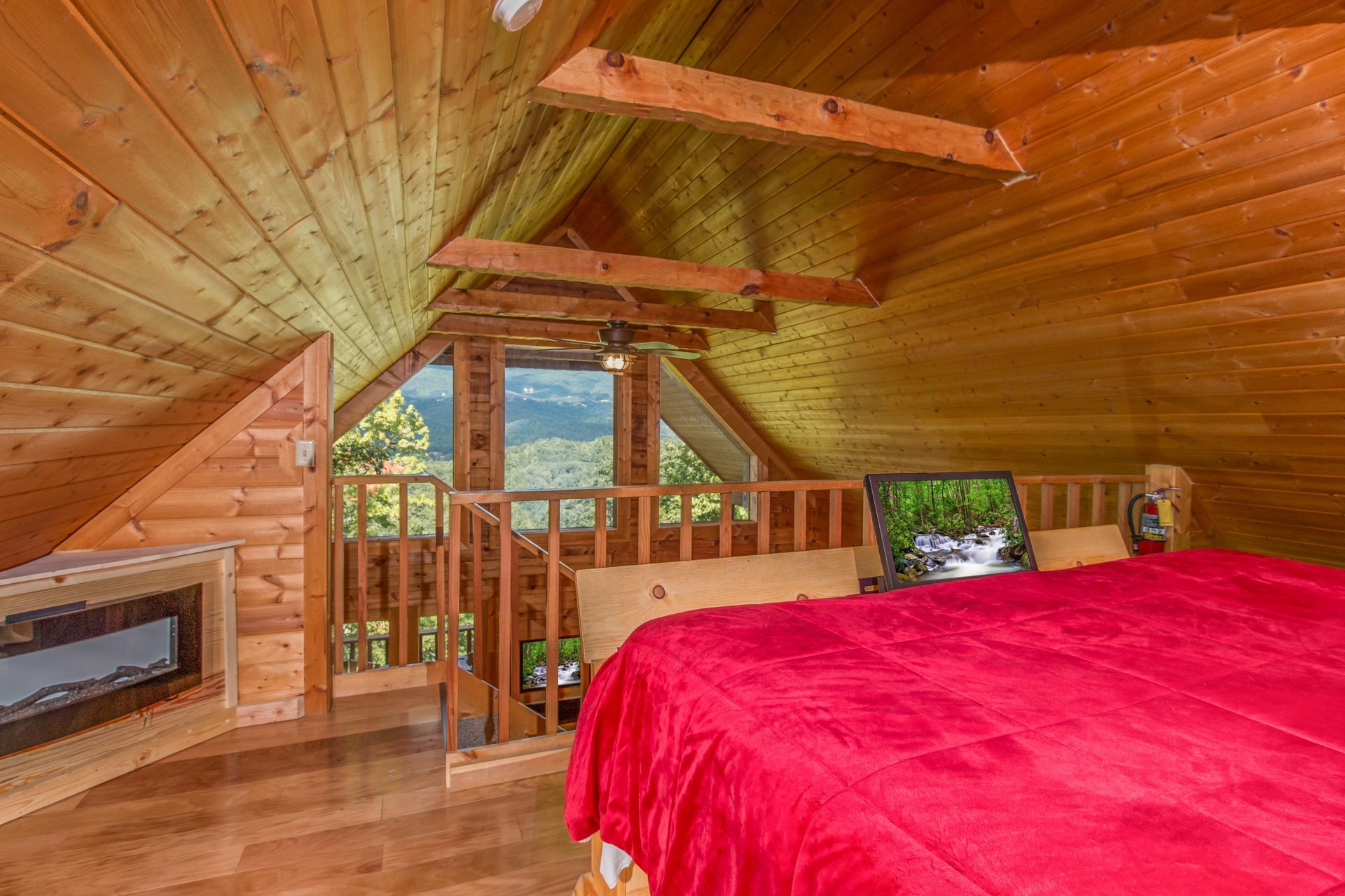 Fireplace and mountain view in the loft bedroom at Cupids Crossing, a 1 bedroom cabin rental located in Pigeon Forge