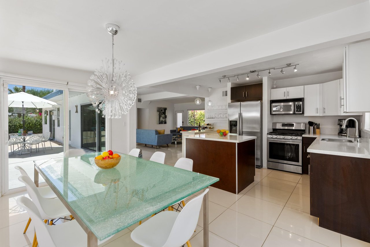 Dining area adjacent to the kitchen has a large table and seating for up to 8 guests.