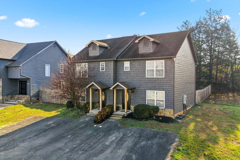 Charming multilevel home with twin covered entrances and private driveway, nestled in a peaceful residential setting.