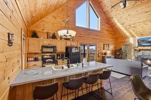 Gather around your spacious kitchen island where rustic charm meets modern convenience in this stunning log cabin retreat.