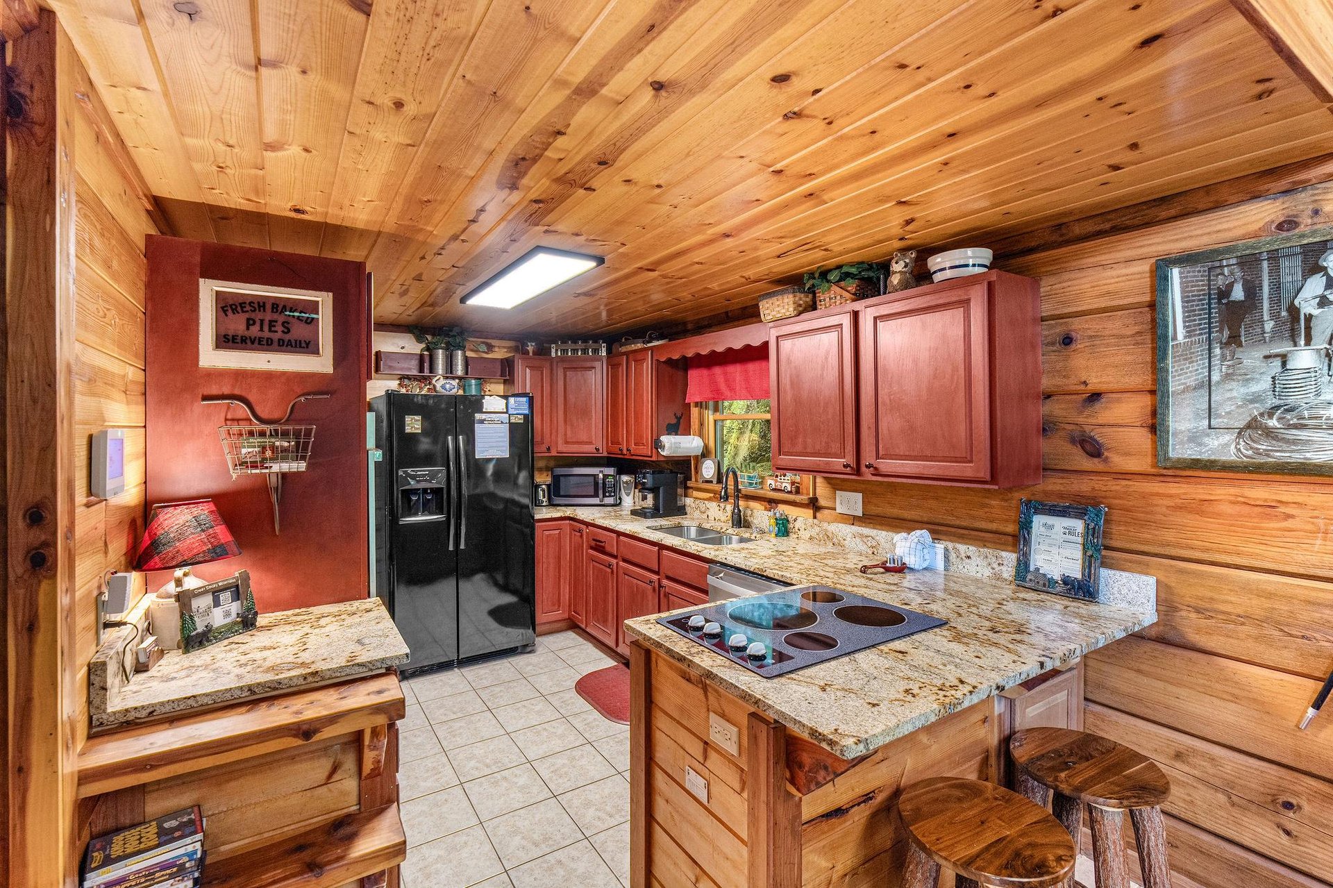 Full kitchen with red wood cabinets