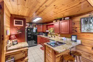 Full kitchen with red wood cabinets