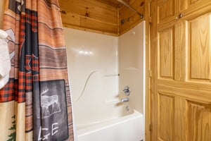 Bathroom with a tub and shower at Absolutely Wonderful, a 2 bedroom cabin rental located in Pigeon Forge