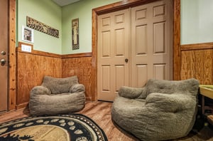 Sink into these plush bean bag chairs and unwind in your cozy rustic retreat with beautiful wood paneling.