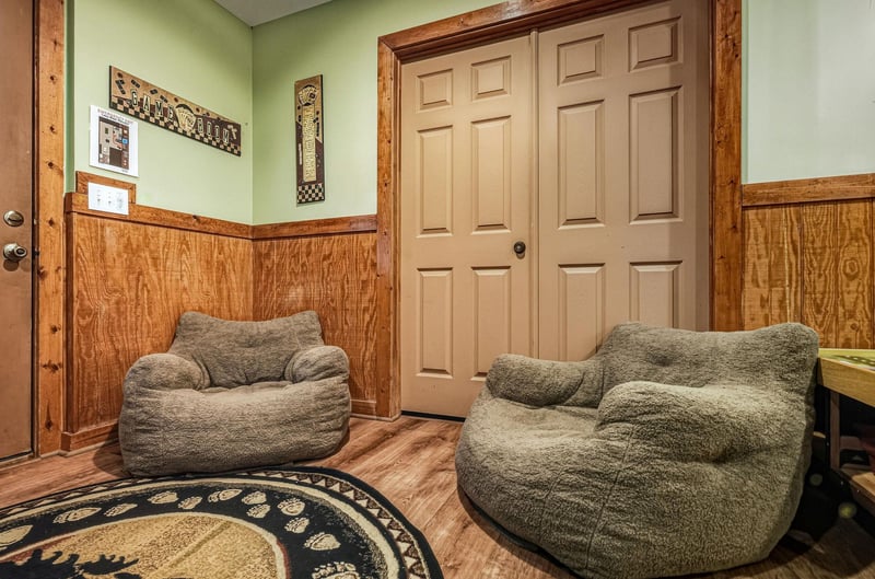 Sink into these plush bean bag chairs and unwind in your cozy rustic retreat with beautiful wood paneling.