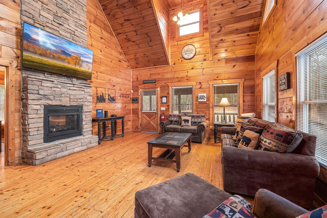 Sofa and chair in the living room at Moonshine Memories, a 2 bedroom cabin rental located in Gatlinburg