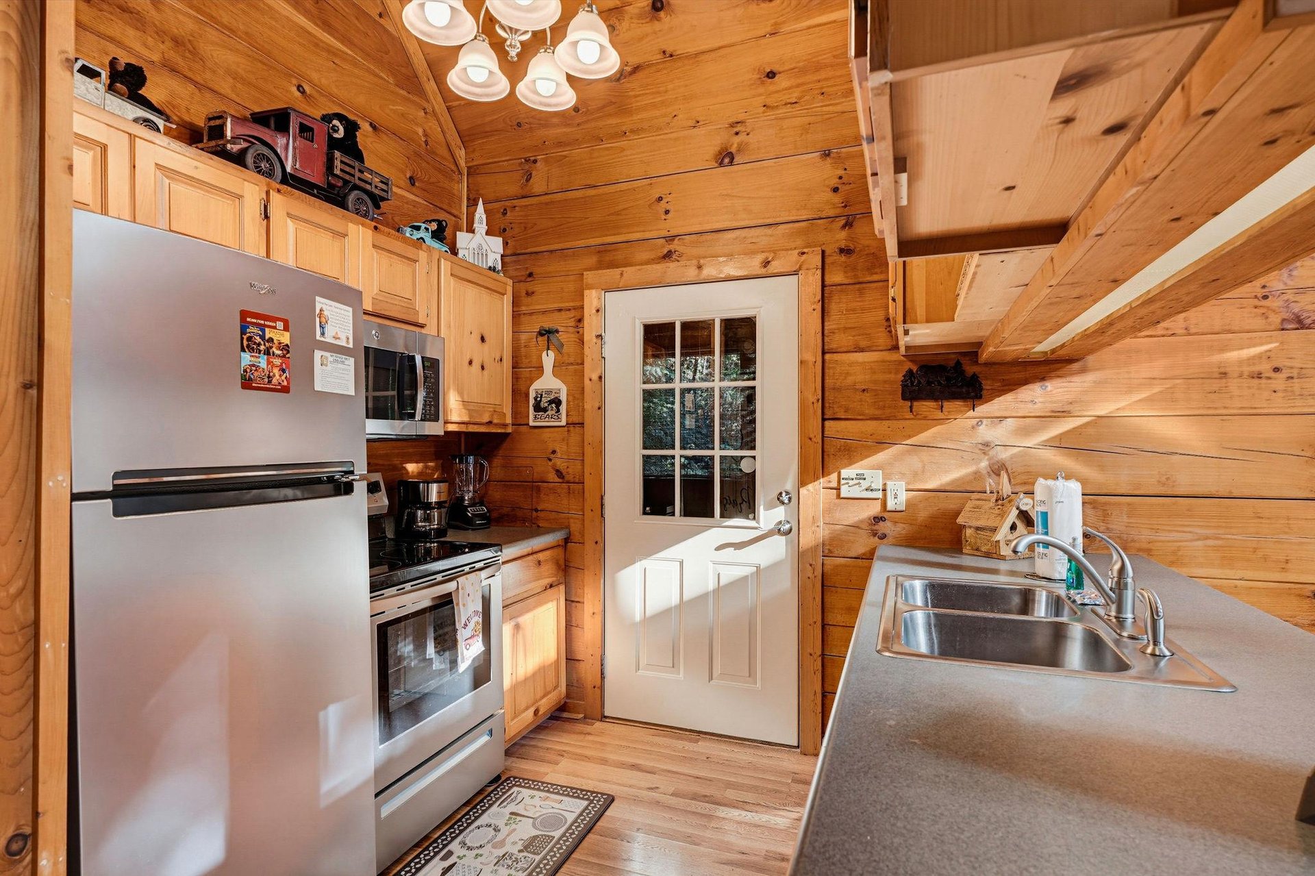 Step into your cozy cabin kitchen, complete with everything you need to prepare a homemade meal amid warm wood walls and rustic charm.