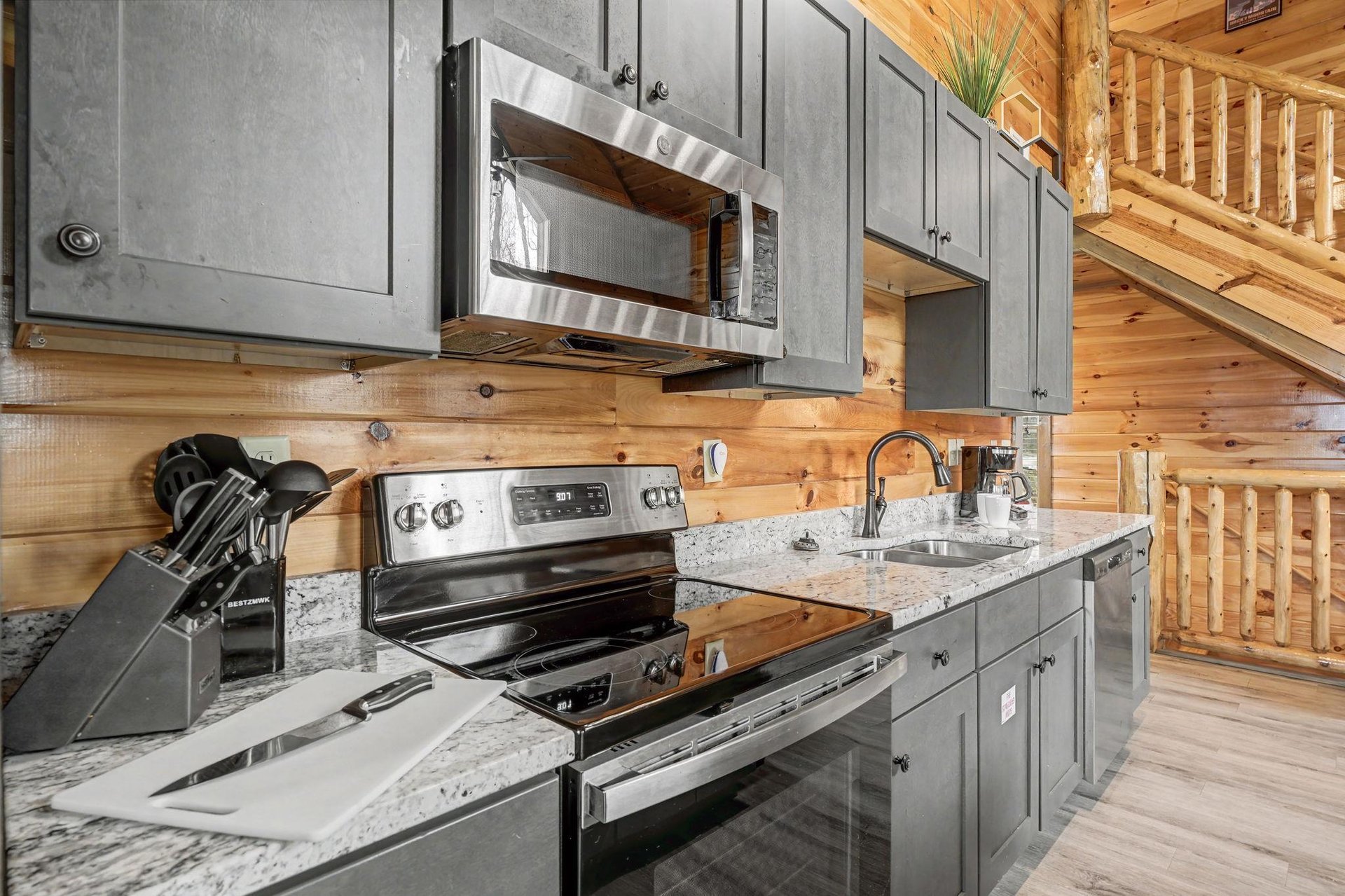 Your mountain retreats modern kitchen features granite counters, stainless appliances, and rustic wood walls—perfect for preparing memorable meals.