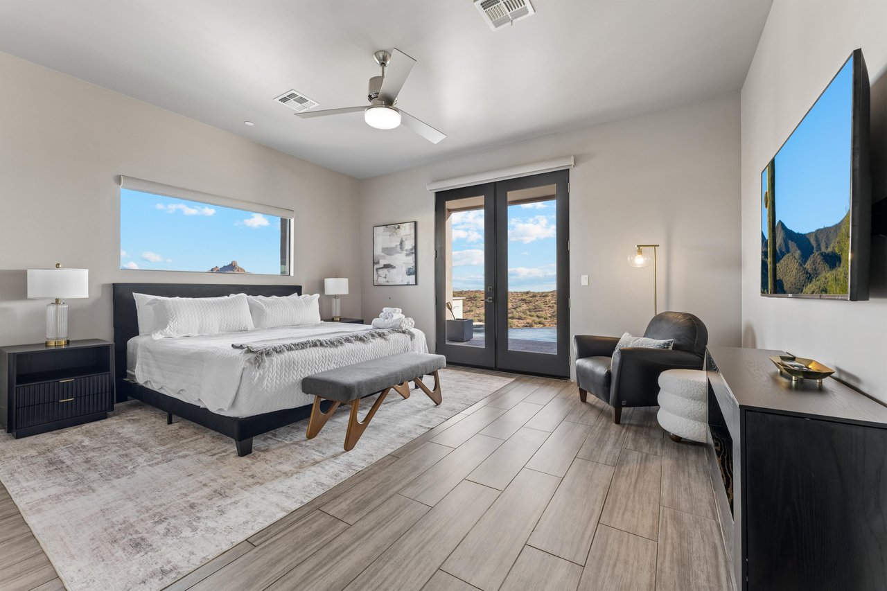 King size bed, doors directly out to the patiopool area, flatscreen TV, mountainpool views, walkin closet, and ensuite bathroom.