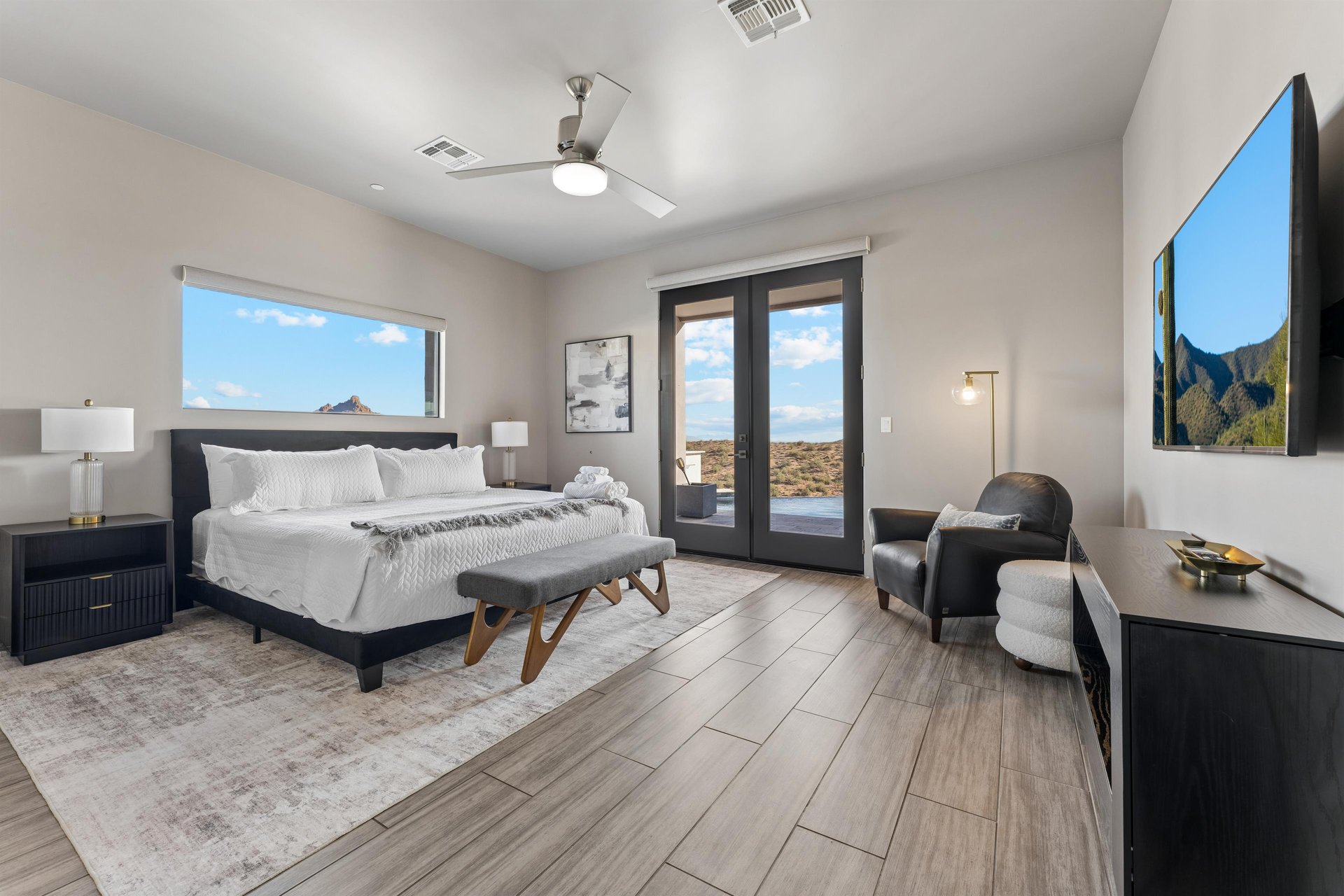 King size bed, doors directly out to the patiopool area, flatscreen TV, mountainpool views, walkin closet, and ensuite bathroom.