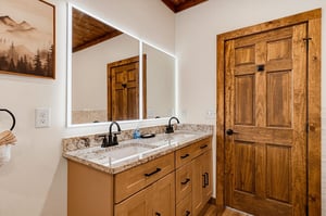 Step into your private bathroom retreat with dual sinks, granite counters, and LEDlit mirrors. Rustic wood details and vaulted ceilings create a warm, spalike ambiance.