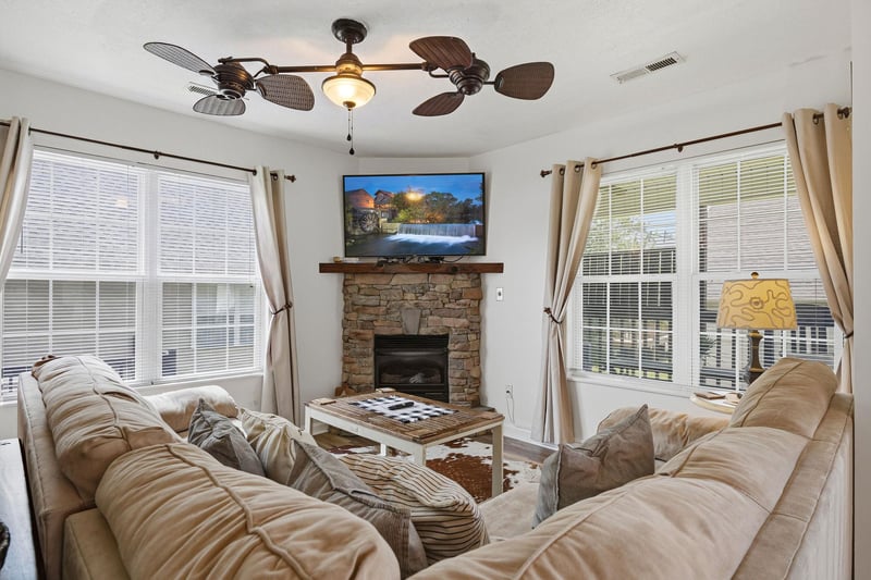 Sink into plush sofas beside a cozy stone fireplace. Natural light streams through generous windows while your favorite shows play on the flatscreen above the mantle.