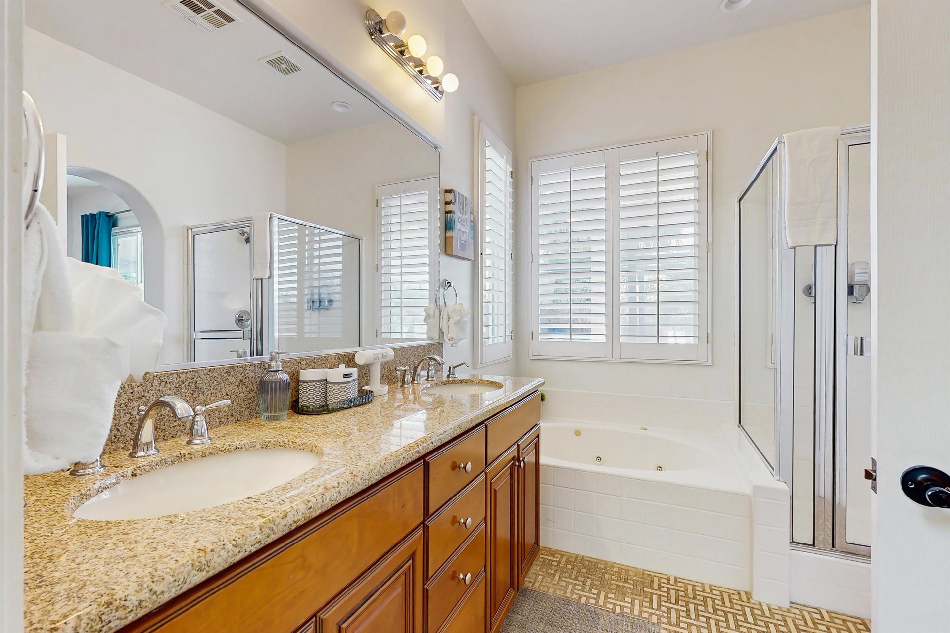 Walkin shower, jet tub, and dual vanity sinks.