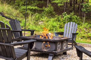 Gather around the crackling fire under the open sky, where Adirondack chairs invite you to unwind and soak in the peaceful forest surroundings.