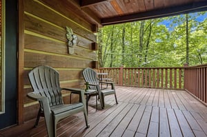 Picture yourself on this private deck, surrounded by lush forest, sipping morning coffee in these cozy Adirondack chairs. The peaceful seclusion invites you to breathe deeply and relax.