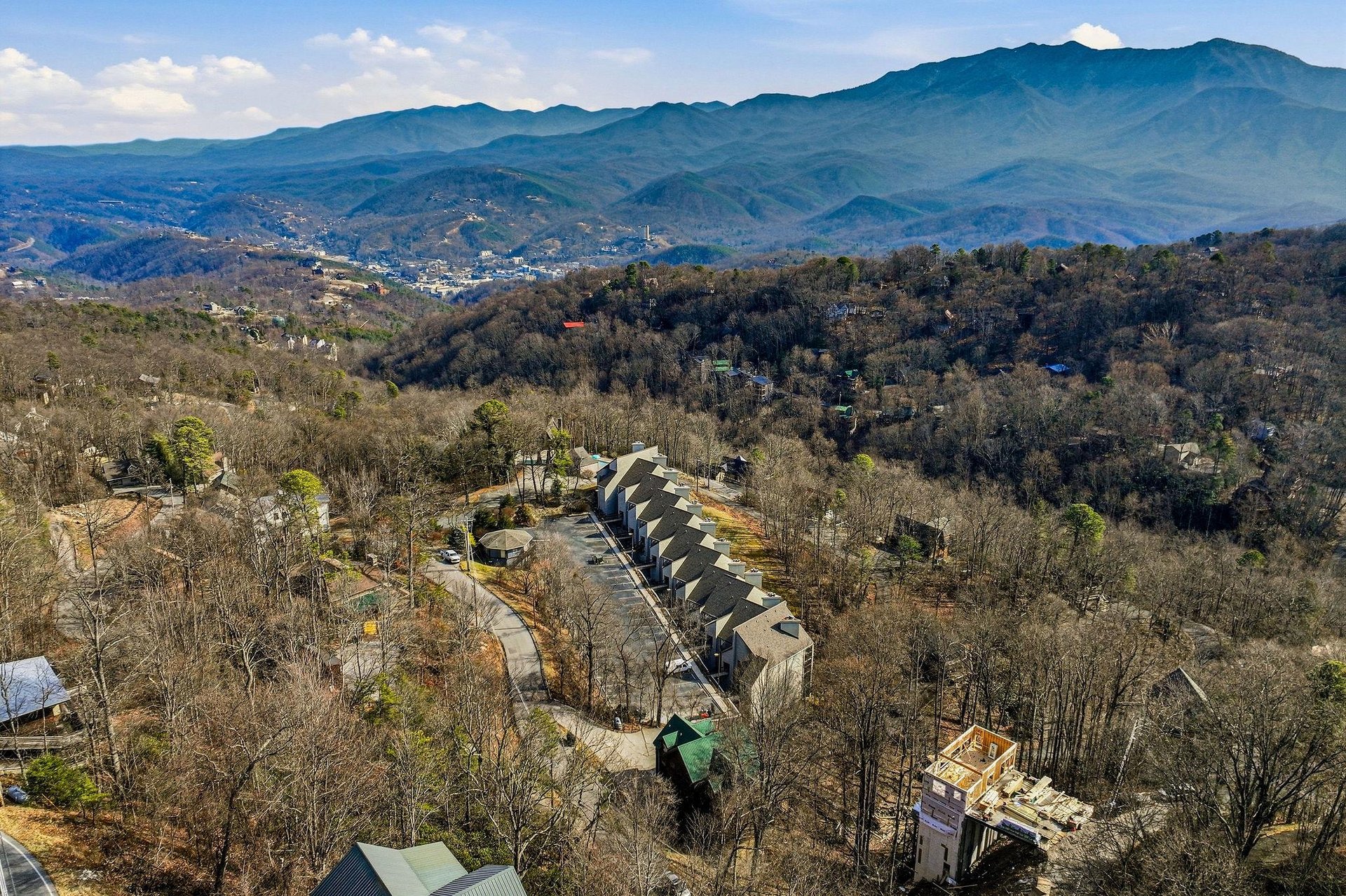 Aerial perspective showcases the property nestled in scenic mountain foothills with sweeping views of the Blue Ridge wilderness.