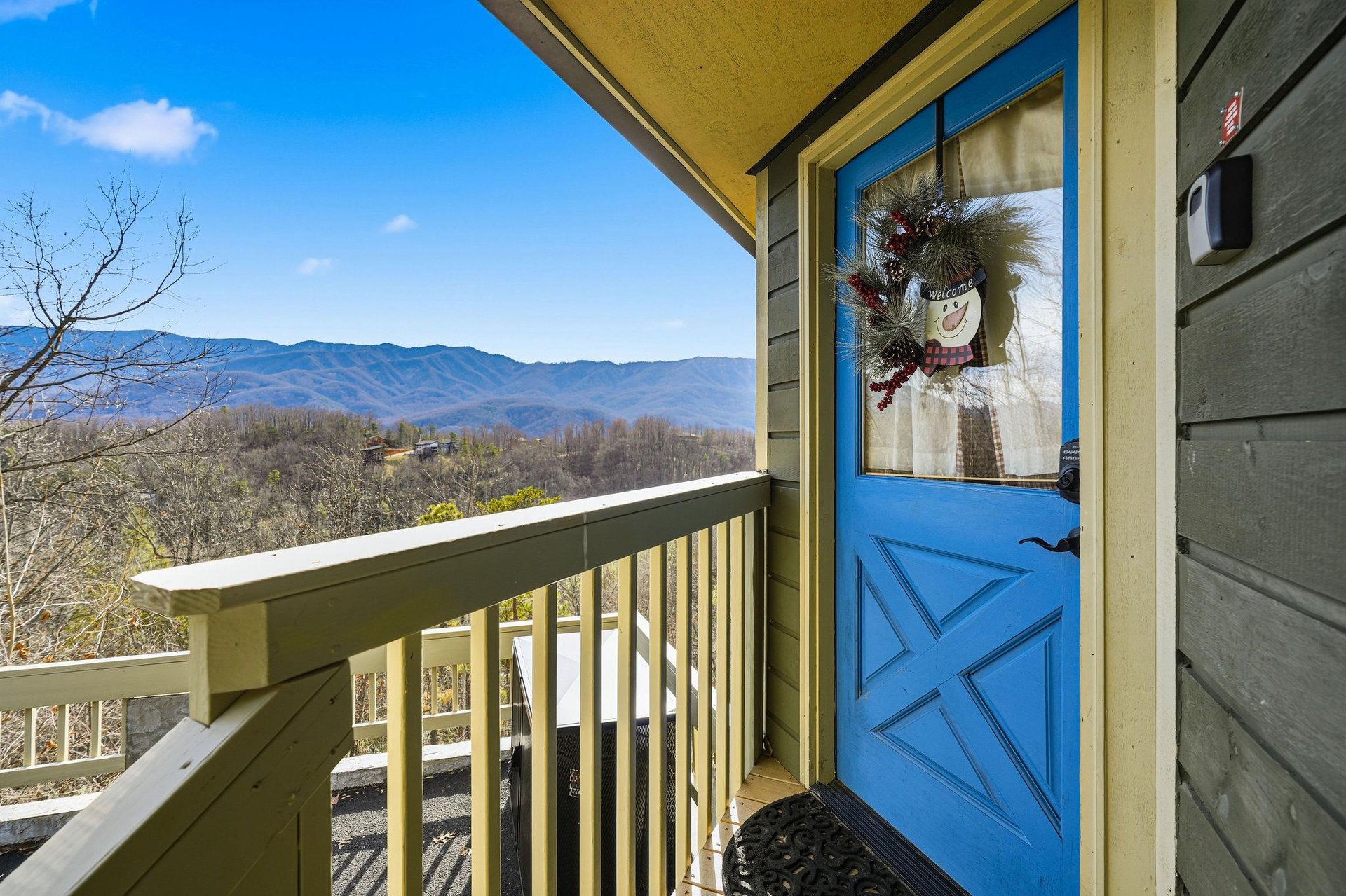 Step into your mountain retreat through this welcoming entrance, where breathtaking mountain vistas await just beyond your door.