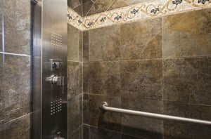 Step into your private spalike shower with elegant marble tiles and luxury fixtures for the perfect start to your day.