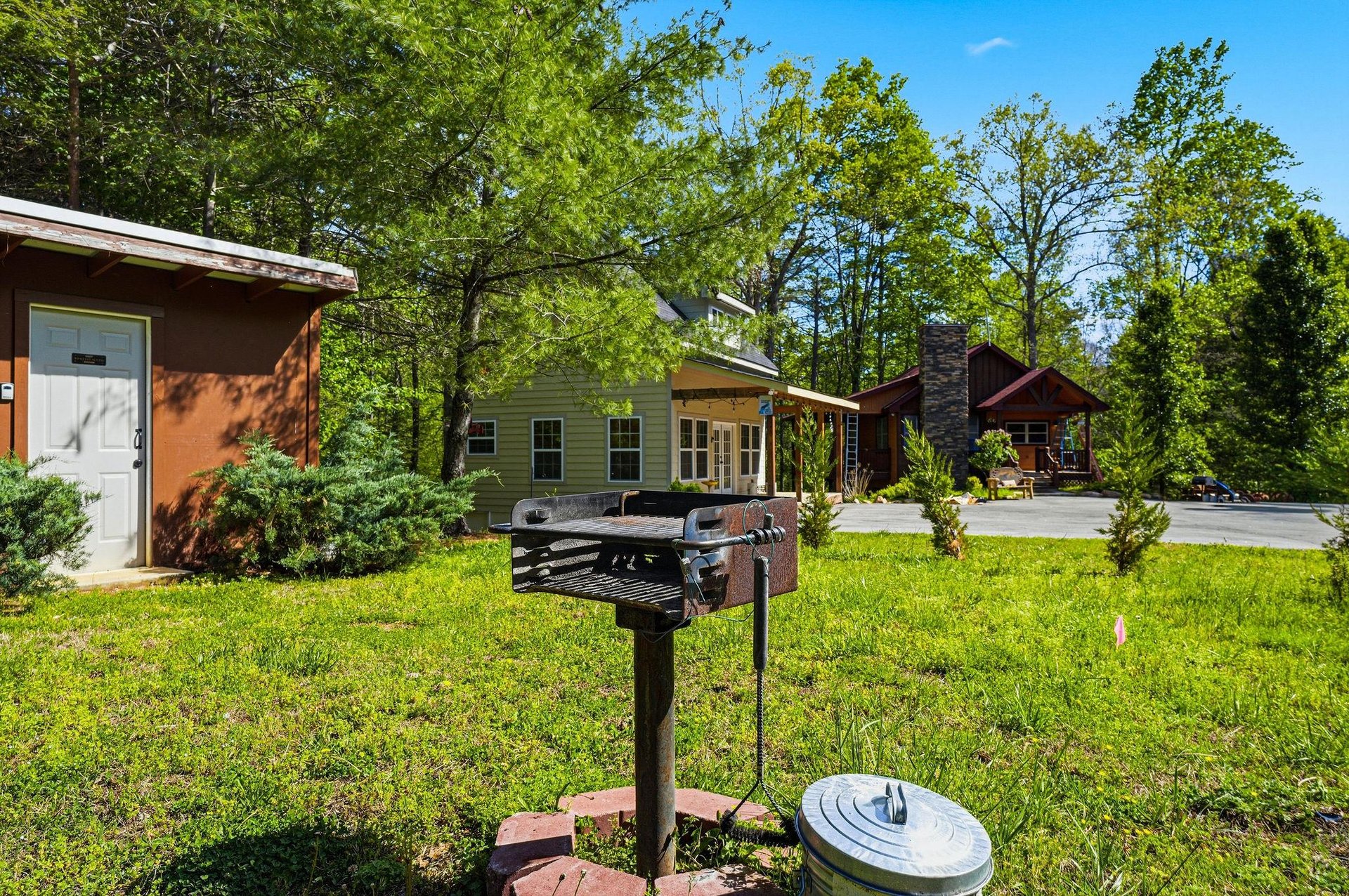Fire up the grill in your private outdoor cooking area, surrounded by peaceful greenery and charming cabin retreats.