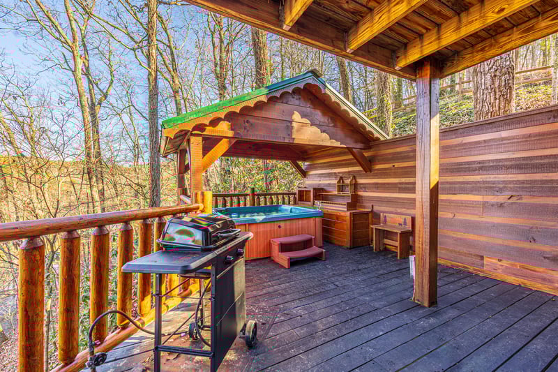 Hot tub on covered deck at Hidden Pleasure