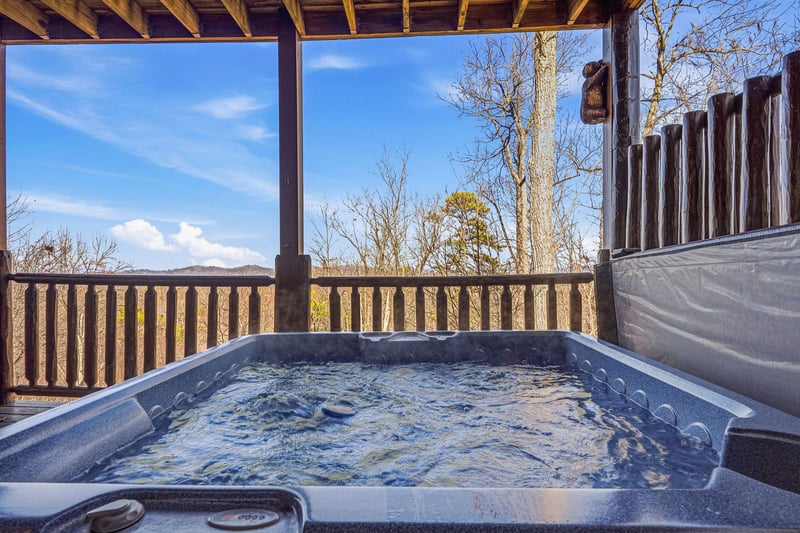 Soak in your private hot tub while taking in stunning mountain views from your covered deck.
