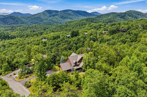 A secluded mountain cabin nestled in lush forest, surrounded by stunning Smoky Mountain views and natural beauty.