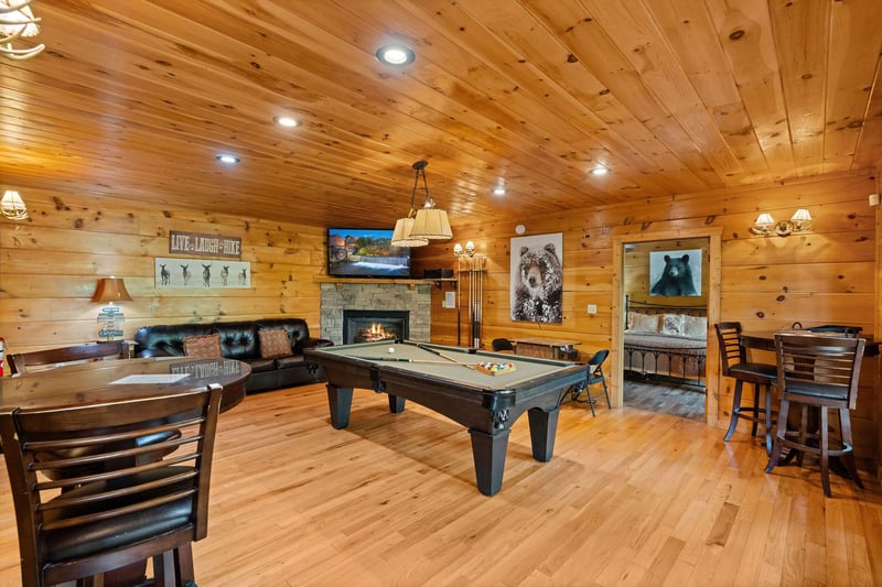 Pool table with stone fireplace and table and chairs