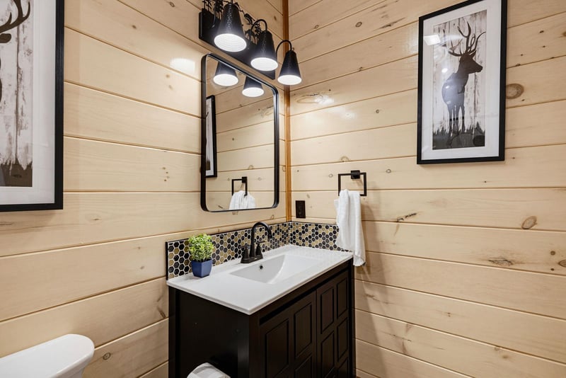Step into this charming bathroom where rustic wood meets modern style, complete with honeycomb backsplash and fresh towels at your fingertips.