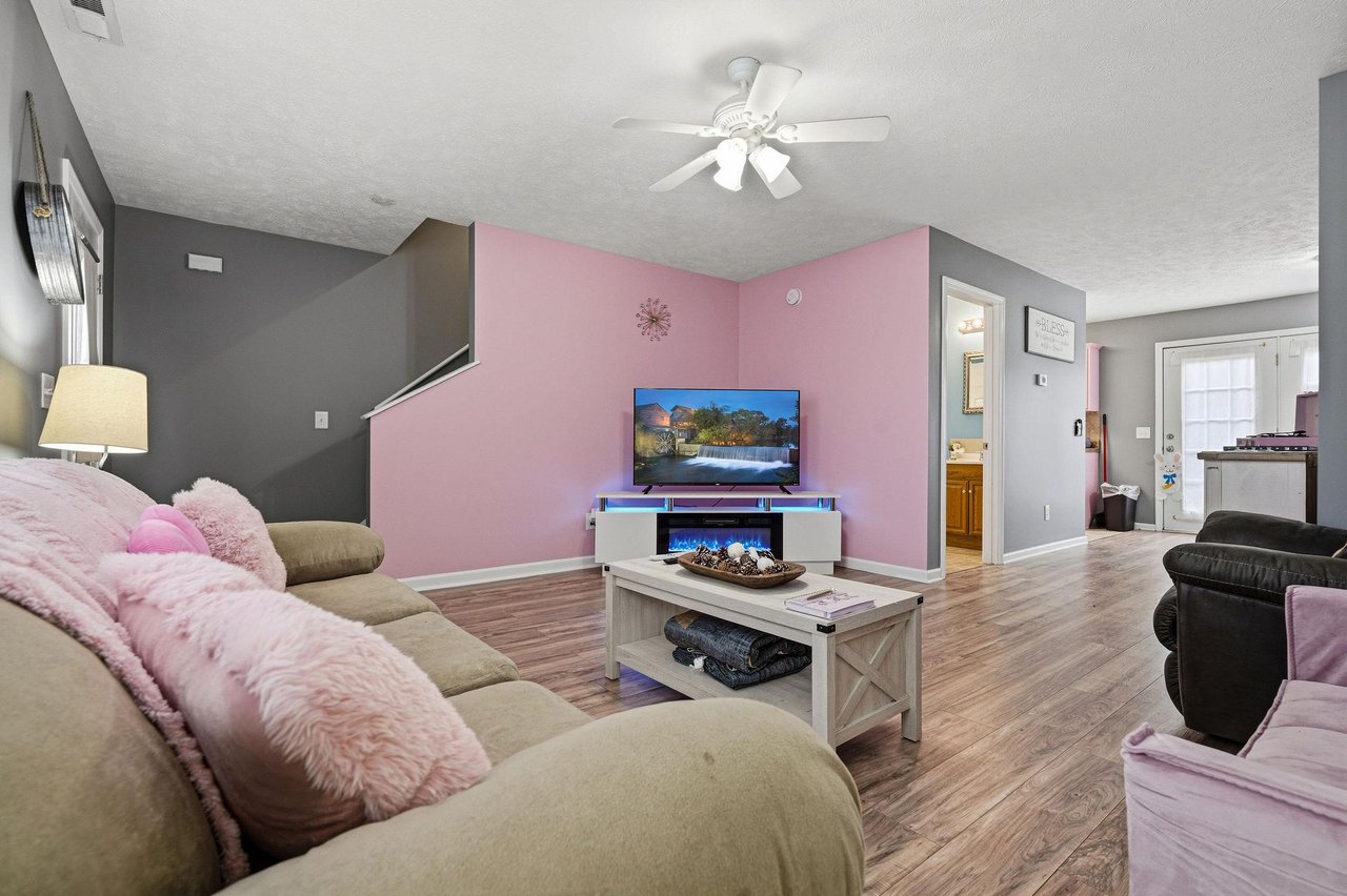 Cozy up in this spacious living room with plush seating, modern fireplace, and entertainment center for your perfect evening retreat.
