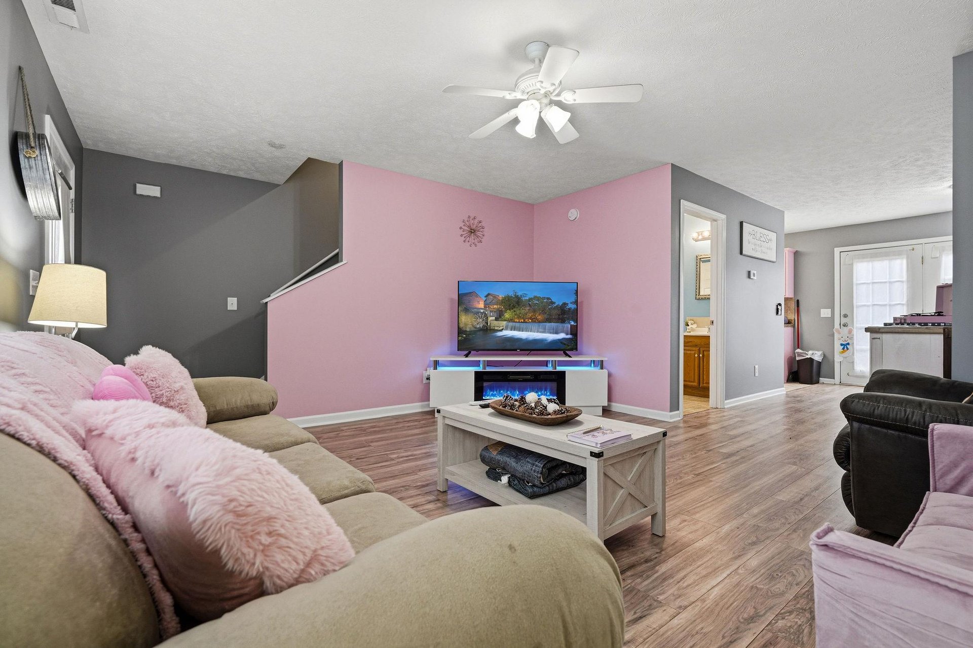 Cozy up in this spacious living room with plush seating, modern fireplace, and entertainment center for your perfect evening retreat.