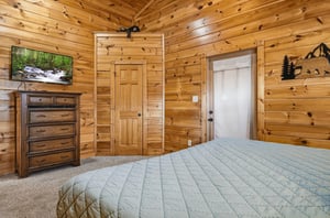 Drift off to sleep surrounded by warm knotty pine walls in your cozy cabin bedroom.