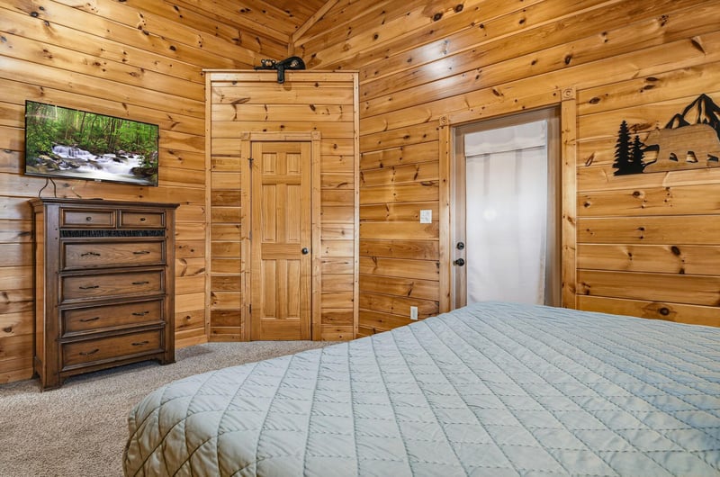 Drift off to sleep surrounded by warm knotty pine walls in your cozy cabin bedroom.