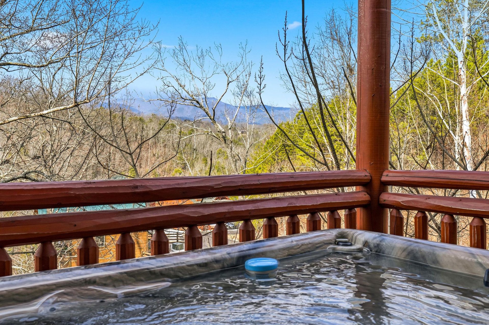 Soak in your private hot tub while gazing at stunning mountain vistas through the trees—pure bliss awaits.