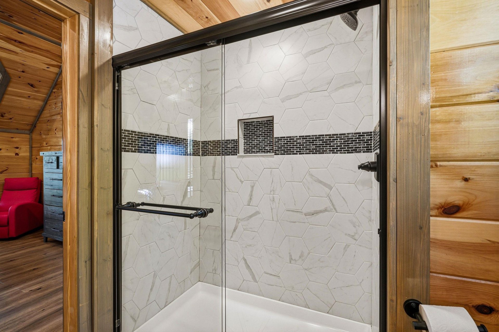 Step into your elegant marbletiled shower featuring sleek hexagonal walls and stylish mosaic accents for a luxurious bathing experience.