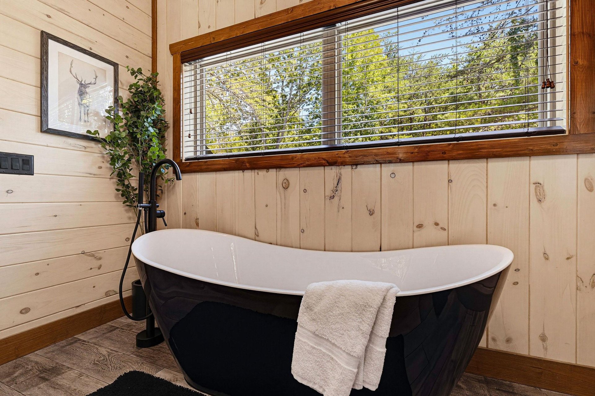Sink into this elegant freestanding tub and let the sunlight through the trees wash your worries away.