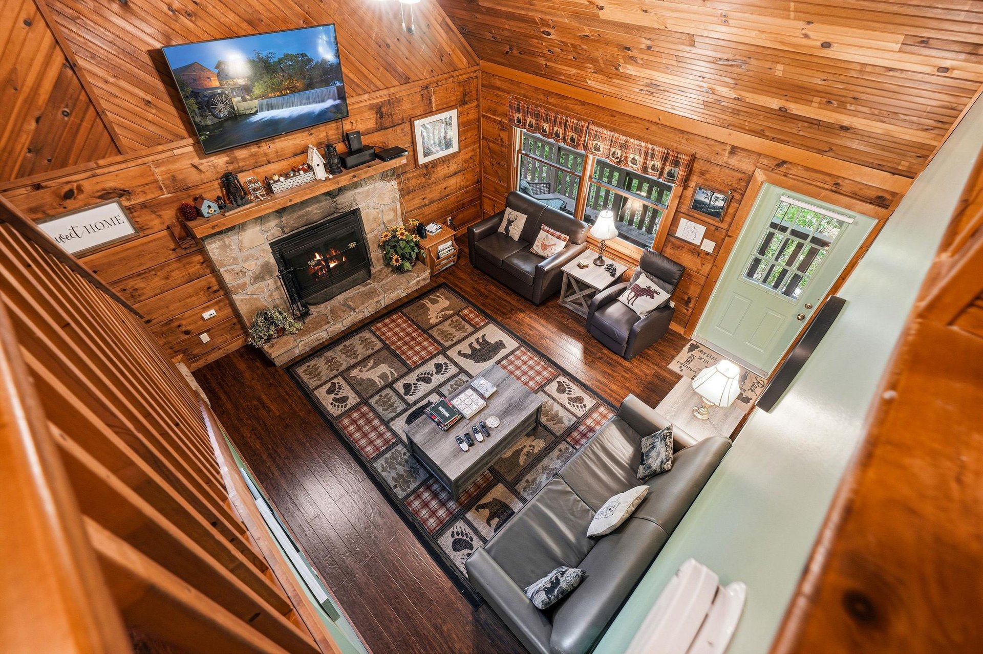 Cozy up by your stone fireplace while enjoying mountain views on the flatscreen TV in this warm cabin retreat.