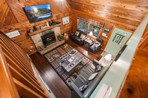 Cozy up by your stone fireplace while enjoying mountain views on the flatscreen TV in this warm cabin retreat.