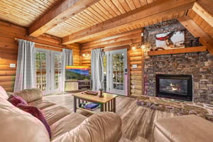 Living room with a TV at Living on Love, a 2 bedroom cabin rental located in Pigeon Forge