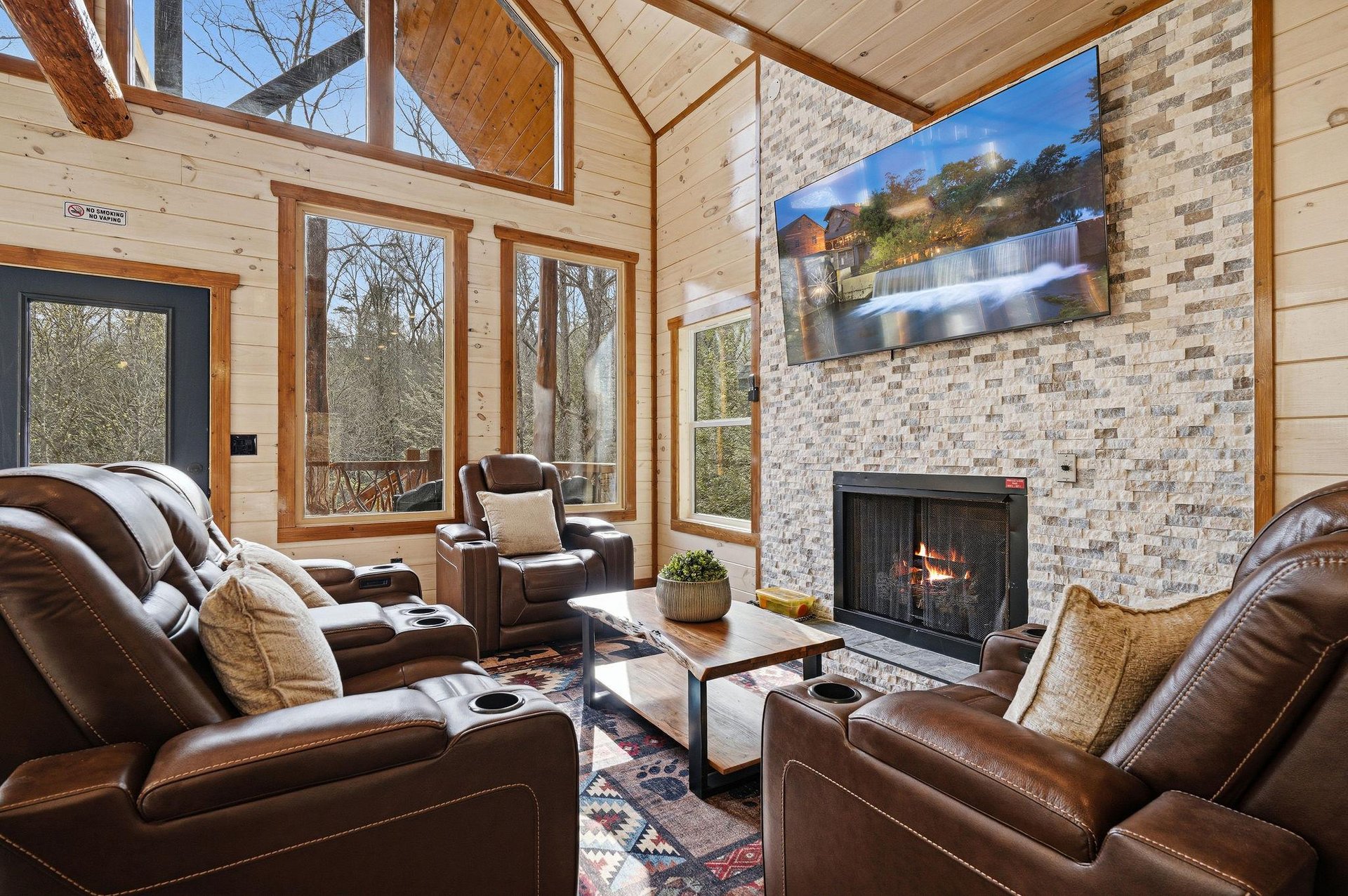 Sink into plush leather recliners by your crackling fireplace, surrounded by soaring windows that frame natures beauty in this cozy mountain retreat.