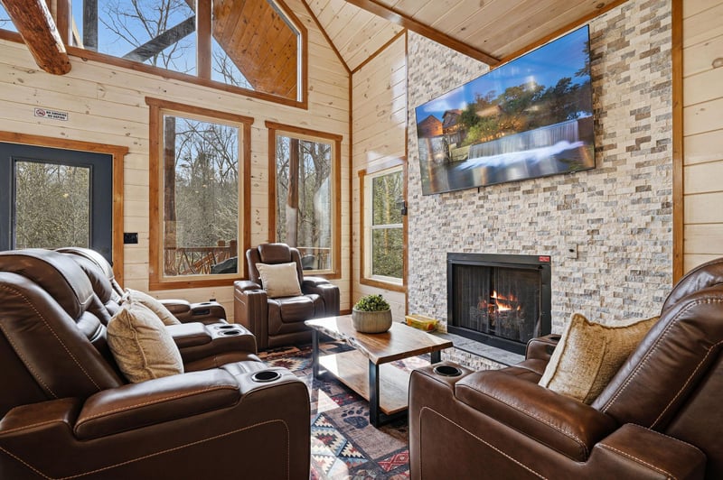 Sink into plush leather recliners by your crackling fireplace, surrounded by soaring windows that frame natures beauty in this cozy mountain retreat.