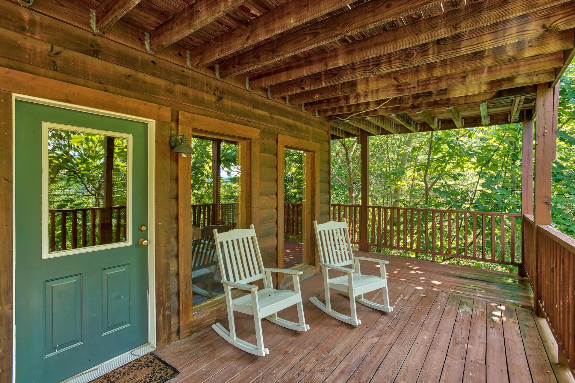 rocking chairs on a covered deck at angels majestic view a 3 bedroom cabin rental located in pigeon forge